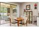 Cozy dining room with a wood table, view of the screened in lanai, and natural light at 1987 Trillium Blvd, Brooksville, FL 34604