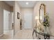 Inviting foyer with tile flooring, decorative mirror, table with floral arrangement, and a view into other rooms at 1987 Trillium Blvd, Brooksville, FL 34604