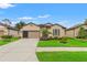 Charming single-story home with well-maintained lawn, a two car garage and beautiful landscaping at 1987 Trillium Blvd, Brooksville, FL 34604