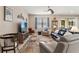 Comfortable living room with a large television, ceiling fan and neutral color palette at 1987 Trillium Blvd, Brooksville, FL 34604