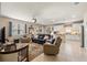 Open-concept living room with tile flooring, ceiling fan, and view of the kitchen at 1987 Trillium Blvd, Brooksville, FL 34604