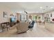 Open-concept living room showcasing tile flooring, a ceiling fan, modern furniture, and a seamless flow into the dining area at 1987 Trillium Blvd, Brooksville, FL 34604