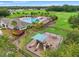 Aerial view of the community playground and pool area with lush landscaping, offering recreational amenities at 1987 Trillium Blvd, Brooksville, FL 34604