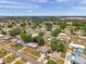 A community featuring a mix of single-Gathering homes, mature trees, and accessible roads in an attractive aerial shot at 2012 Warrington Way, Tampa, FL 33619