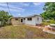 This home features a cozy backyard with a small brick patio and adjacent shed, perfect for entertaining at 2012 Warrington Way, Tampa, FL 33619