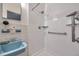 Close-up of a bright bathroom featuring a blue sink, tiled walls, and a shower with modern fixtures at 2012 Warrington Way, Tampa, FL 33619