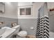 This bathroom features a sink, toilet, window, and tile walls at 2012 Warrington Way, Tampa, FL 33619