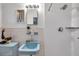 Bright bathroom featuring a blue sink, tiled walls, shower with modern fixtures, and unique vintage design at 2012 Warrington Way, Tampa, FL 33619