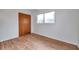 Bright bedroom featuring wood flooring, a closet, and a window that provides natural light at 2012 Warrington Way, Tampa, FL 33619