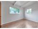 Bright bedroom featuring wood flooring, and a large window offering natural light at 2012 Warrington Way, Tampa, FL 33619