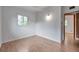 Bright bedroom featuring wood flooring, white walls, natural light, and a neutral design at 2012 Warrington Way, Tampa, FL 33619