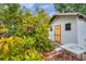 View of the exterior of the shed with a small concrete patio and lush vegetation, creating a secluded space at 2012 Warrington Way, Tampa, FL 33619
