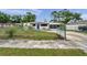 Charming home featuring a well-maintained yard, screened in porch, and long driveway at 2012 Warrington Way, Tampa, FL 33619