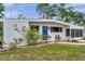Charming home's exterior, showcasing the textured facade and front yard landscaping at 2012 Warrington Way, Tampa, FL 33619