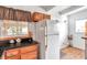 The updated kitchen features wood cabinets, stainless appliances and a tile backsplash at 2012 Warrington Way, Tampa, FL 33619