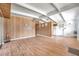 The open living room boasts wood-look floors, beams and is open to the kitchen at 2012 Warrington Way, Tampa, FL 33619