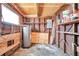 The interior of this shed has great storage, with unfinished wooden walls, open shelving, and concrete flooring at 2012 Warrington Way, Tampa, FL 33619