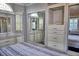 Comfortable bedroom featuring sliding mirror closets and built in dresser storage space at 21040 Lazy Days Cir, Lutz, FL 33558