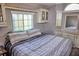 Cozy bedroom with a comfortable bed, built-in storage, and a window for natural light at 21040 Lazy Days Cir, Lutz, FL 33558