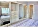 Bedroom showing closet with mirror doors and built in dresser and shelves at 21040 Lazy Days Cir, Lutz, FL 33558