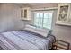 Inviting bedroom features a comfy bed, built-in cabinets, a sunny window, and stylish decor at 21040 Lazy Days Cir, Lutz, FL 33558