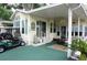 Charming home exterior featuring a covered porch, well-manicured landscaping, and a convenient golf cart parking area at 21040 Lazy Days Cir, Lutz, FL 33558