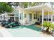 Charming home exterior featuring a covered porch, well-manicured landscaping, and a convenient golf cart parking area at 21040 Lazy Days Cir, Lutz, FL 33558