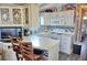 Well-lit kitchen featuring white cabinets, modern appliances, and a breakfast bar with comfortable seating at 21040 Lazy Days Cir, Lutz, FL 33558