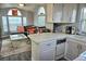 This is an open-concept kitchen and living room space with nice furniture and plenty of natural light at 21040 Lazy Days Cir, Lutz, FL 33558