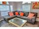 Comfortable living room with plenty of natural light, featuring a plush sectional sofa, modern coffee table, and stylish decor at 21040 Lazy Days Cir, Lutz, FL 33558