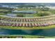 A vast aerial shot showcasing the community with lakeside houses near roadways at 3051 Francoa Dr, Odessa, FL 33556