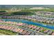 Expansive aerial view of a community with picturesque homes nestled alongside a serene lake at 3051 Francoa Dr, Odessa, FL 33556