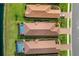 An overhead view of the homes with terra cotta roofs, in-ground pools, and verdant landscaping at 3051 Francoa Dr, Odessa, FL 33556