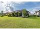 Beautiful backyard with a screened lanai, splash pool, and lush landscaping offering both privacy and outdoor enjoyment at 3051 Francoa Dr, Odessa, FL 33556