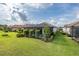 Lovely backyard showcasing a screened lanai, a splash pool, and mature landscaping for a private outdoor retreat at 3051 Francoa Dr, Odessa, FL 33556