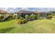 Lush backyard featuring a screen-enclosed pool and manicured shrubs; ideal for relaxation and entertainment at 3051 Francoa Dr, Odessa, FL 33556