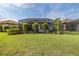 Spacious backyard with a private screened-in lanai and a splash pool, perfect for outdoor enjoyment and entertaining at 3051 Francoa Dr, Odessa, FL 33556