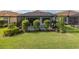 Private backyard featuring a screened lanai, a splash pool, and professional landscaping, perfect for outdoor gatherings at 3051 Francoa Dr, Odessa, FL 33556