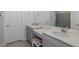 Bathroom features gray cabinets, a white countertop, and a vanity seating area at 3051 Francoa Dr, Odessa, FL 33556