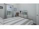 Bedroom with TV, a rocking chair, and a window with a neighborhood view at 3051 Francoa Dr, Odessa, FL 33556