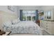 Light bedroom featuring a nautical theme, television, and dresser and is near the sliding door access to the lanai at 3051 Francoa Dr, Odessa, FL 33556