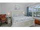 Bright bedroom with large window overlooking the lanai and pool, featuring a nautical theme and comfortable furnishings at 3051 Francoa Dr, Odessa, FL 33556