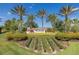 Community sign with lush landscaping and palm trees at 3051 Francoa Dr, Odessa, FL 33556