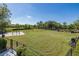 Spacious community dog park with green grass, fencing, and play structures for furry friends at 3051 Francoa Dr, Odessa, FL 33556