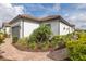 Close-up of a home shows a beautiful garden bed, a walkway, and the facade of the house including the garage at 3051 Francoa Dr, Odessa, FL 33556