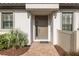 Charming front entrance showcasing a decorative door with sidelight, manicured landscaping, and a brick paver walkway at 3051 Francoa Dr, Odessa, FL 33556