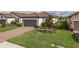 Charming single-story home with a brick driveway and well-manicured landscaping with new plants at 3051 Francoa Dr, Odessa, FL 33556