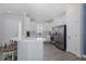 Bright kitchen features white cabinets, stainless steel appliances, a center island, and modern fixtures at 3051 Francoa Dr, Odessa, FL 33556