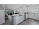 Open-concept kitchen with an island, stainless steel appliances, and seamless flow to the inviting living space at 3051 Francoa Dr, Odessa, FL 33556