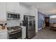 Contemporary kitchen with stainless steel appliances, mosaic backsplash, and gas cooktop, offering a stylish cooking space at 3051 Francoa Dr, Odessa, FL 33556